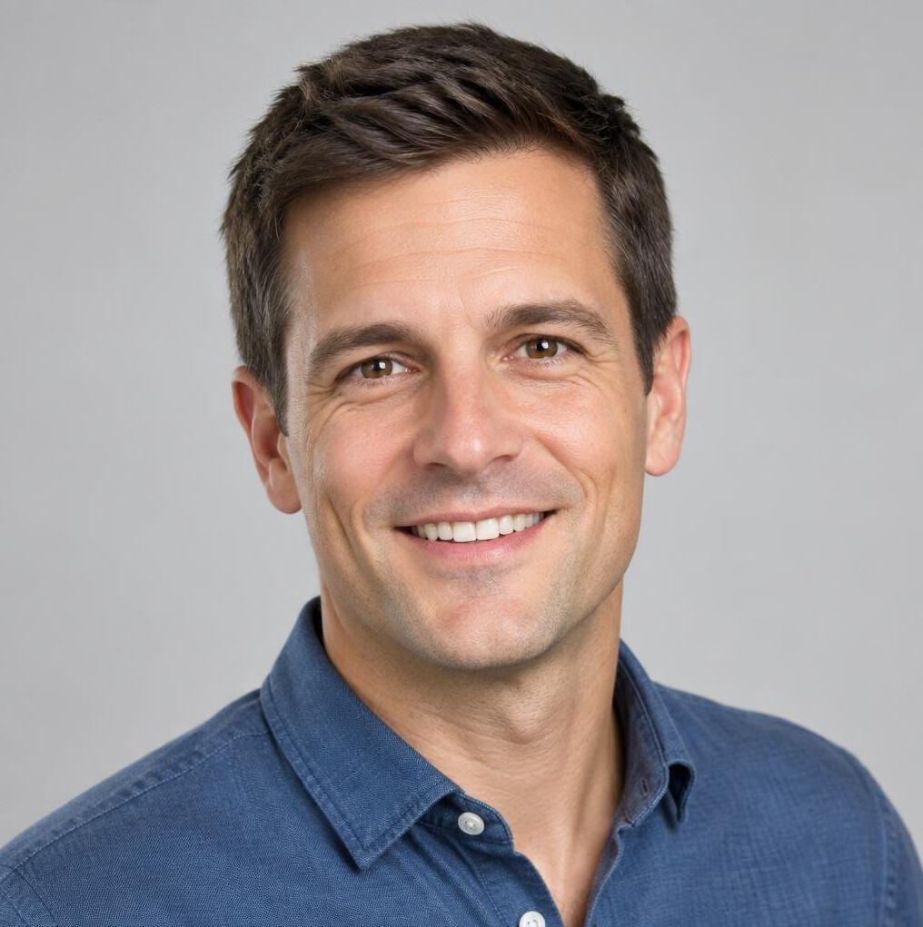 Studio portrait of a man with short dark hair smiling
