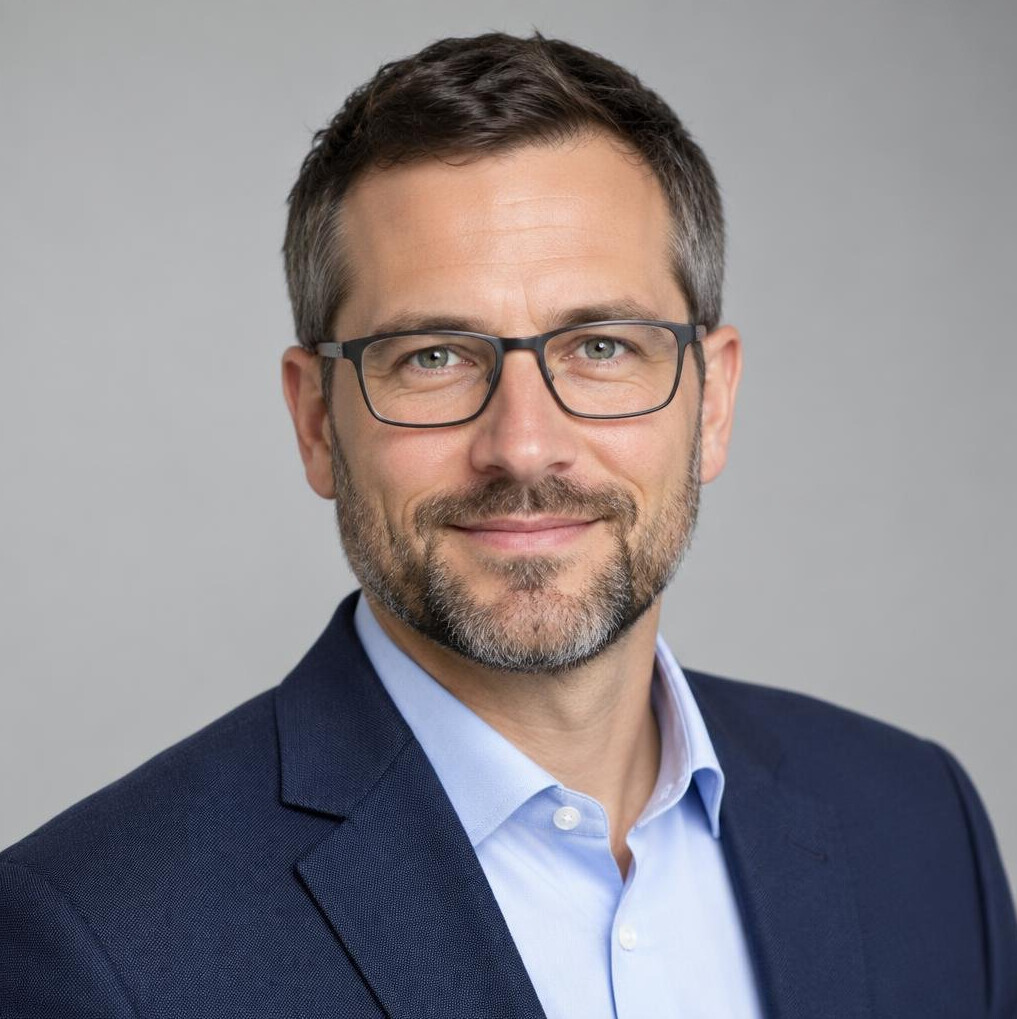 Studio portrait of a man with glasses and a beard