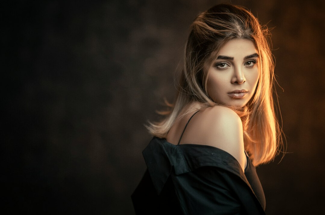 Studio portrait of a young woman with long blonde hair
